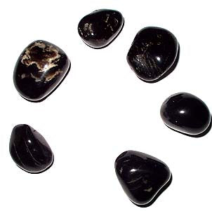 Seven black onyx stones on a white background