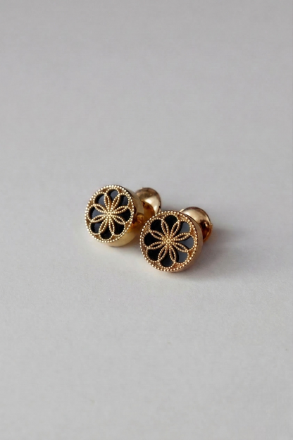 A pair of Gold earrings with a byzantine inspired design. The Ravenna Black Onyx Stud Earrings in 18kt Yellow Gold. 